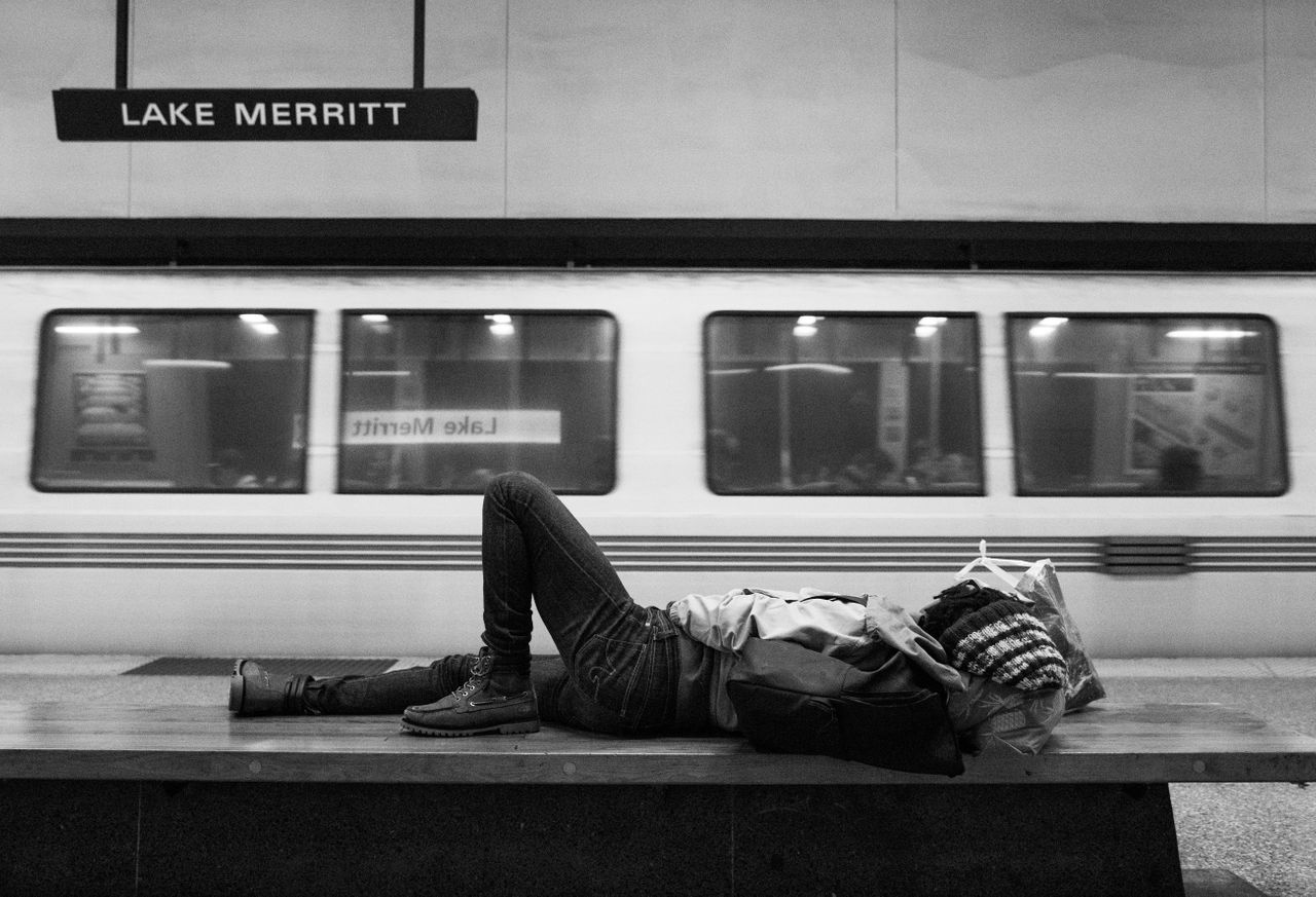 Une femme sans-abri dort sur un banc dans une station BART à Oakland, en Californie.  Raconter l’histoire de la violence contemporaine à l’égard des femmes et des filles noires, c’est faire le point sur la façon dont nous nuisons régulièrement à ceux qui sont en marge.